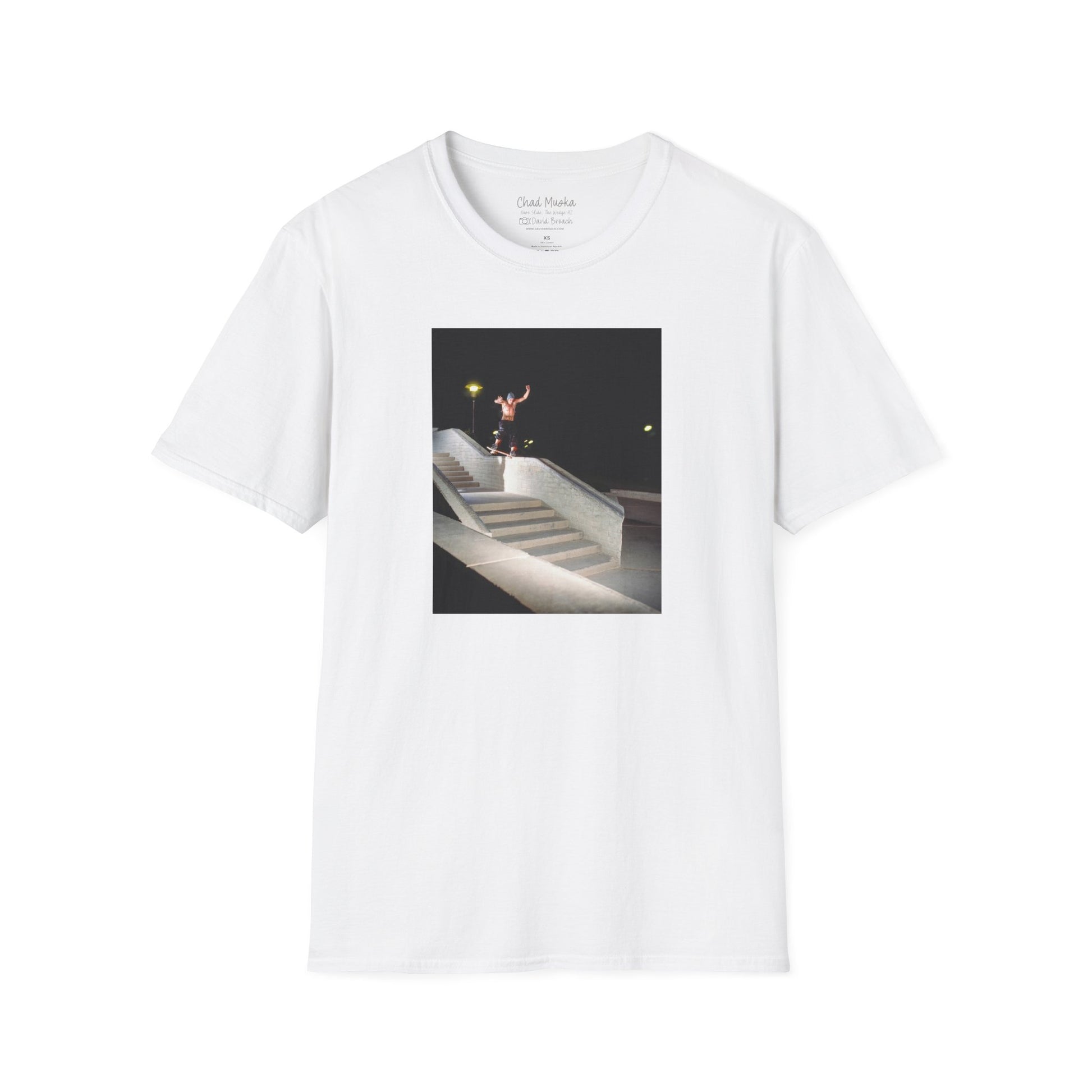 A white crew neck short-sleeve T-shirt featuring a printed photo of A high-quality print featuring an iconic shot of Chad Muska in 1999 executing a smooth nose slide down the triple-kink Hubba rail at The Wedge in Phoenix, Arizona. Captured by photographer David Broach, this image showcases Muska’s signature style and fearless approach, making it a must-have for skateboarding enthusiasts and collectors."