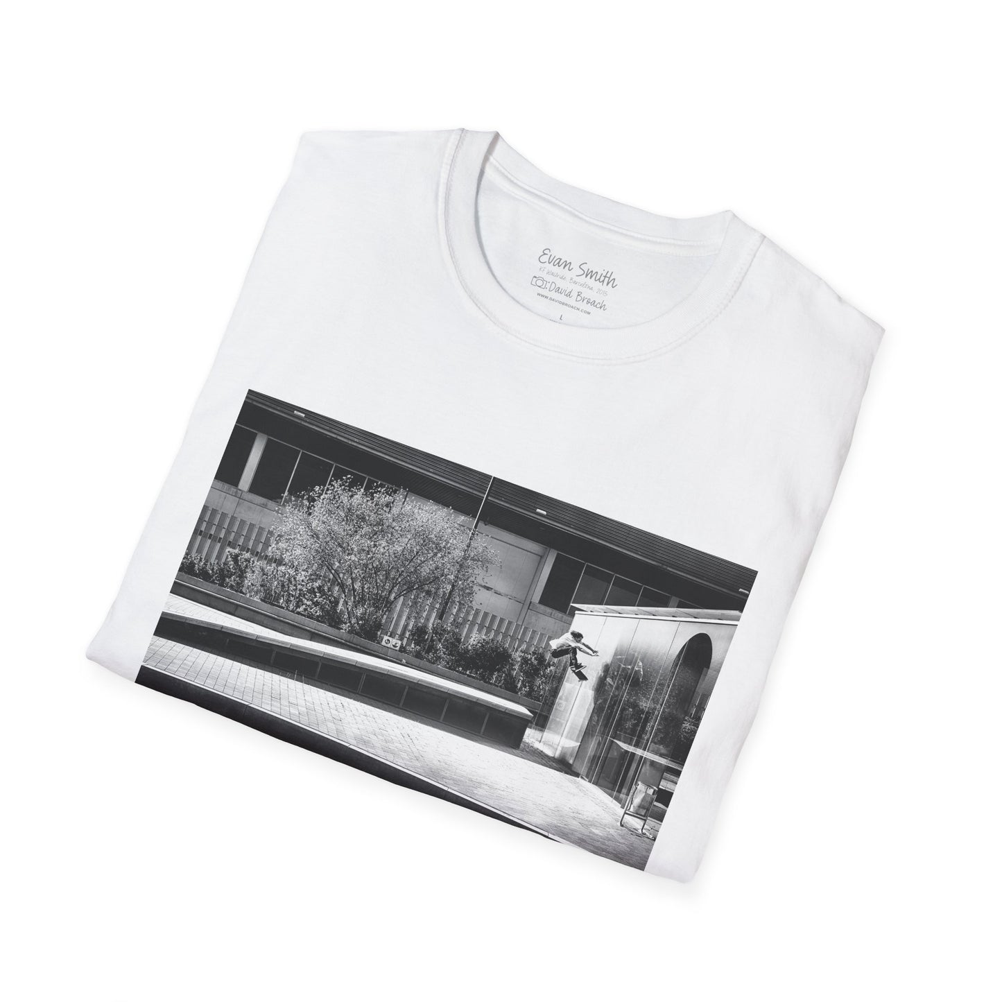 White Shirt folded with print of Black and white photo of Evan Smith doing a kick flip wallride in Barcelona Spain. Off bump onto wall.