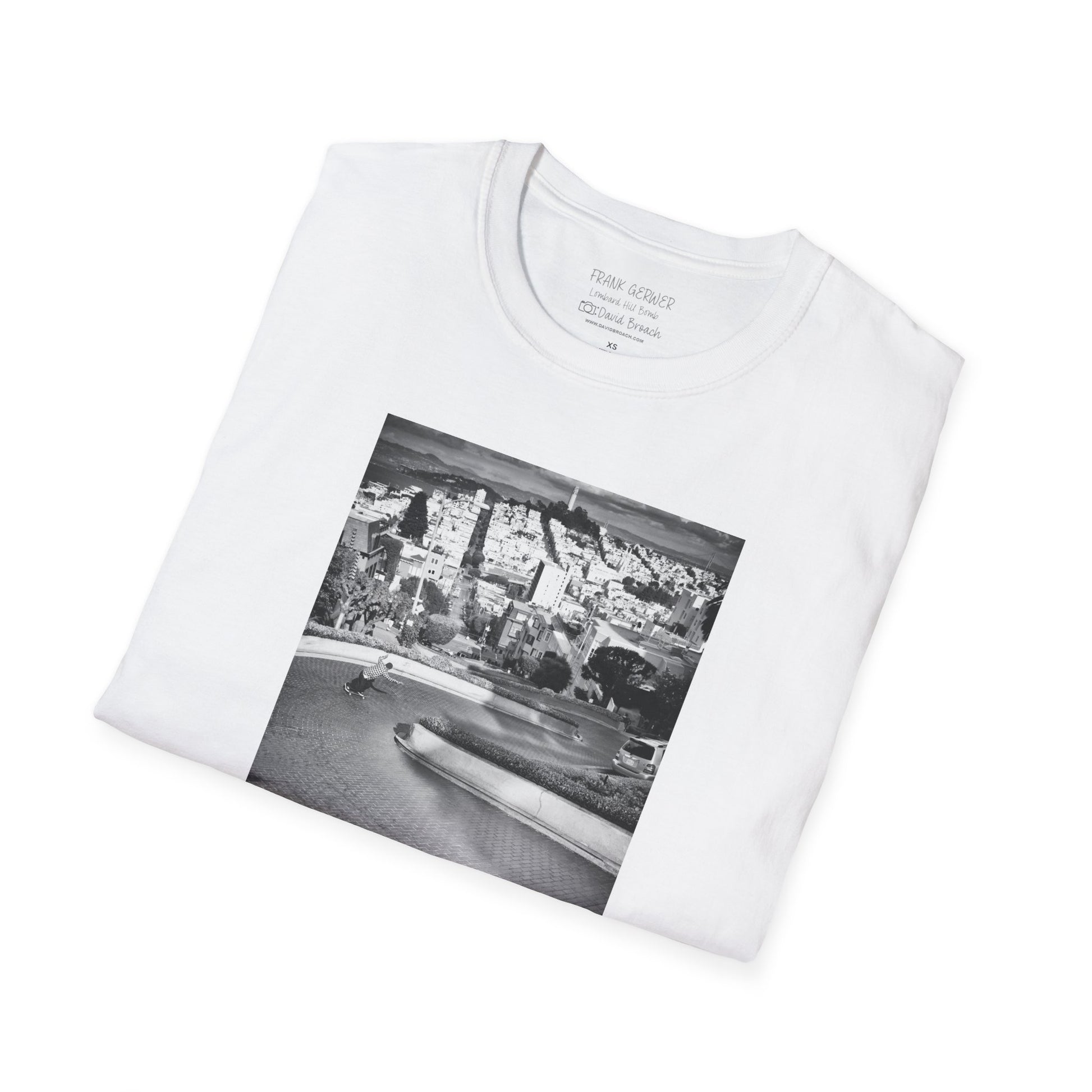 A neatly folded white crew neck short-sleeve T-shirt featuring a printed black-and-white photo of Frank Gerwer riding down the iconic Lombard Street in San Francisco. Captured by photographer David Broach, the design captures Gerwer’s fearless style and the legendary winding street, making it a must-have for skateboarding enthusiasts and streetwear fans.