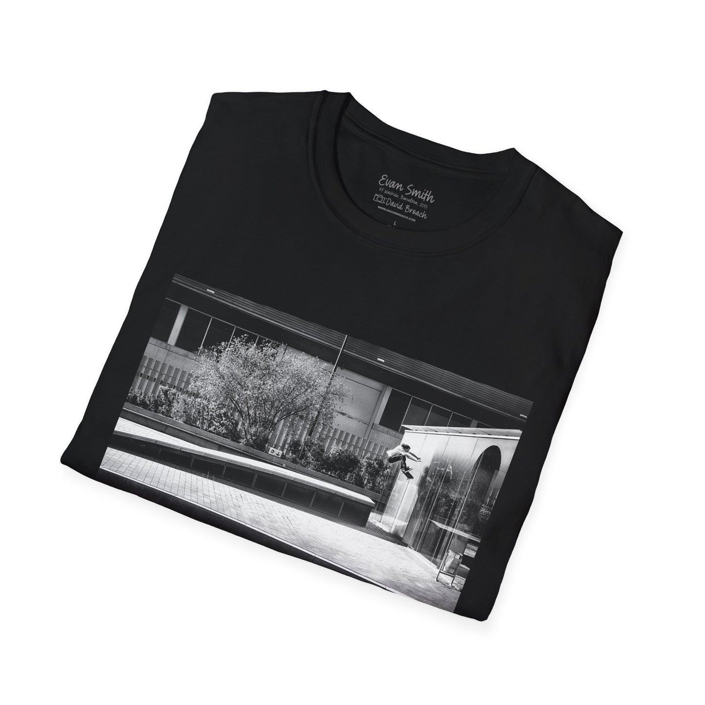 Black Shirt folded with print of Black and white photo of Evan Smith doing a kick flip wallride in Barcelona Spain. Off bump onto wall.