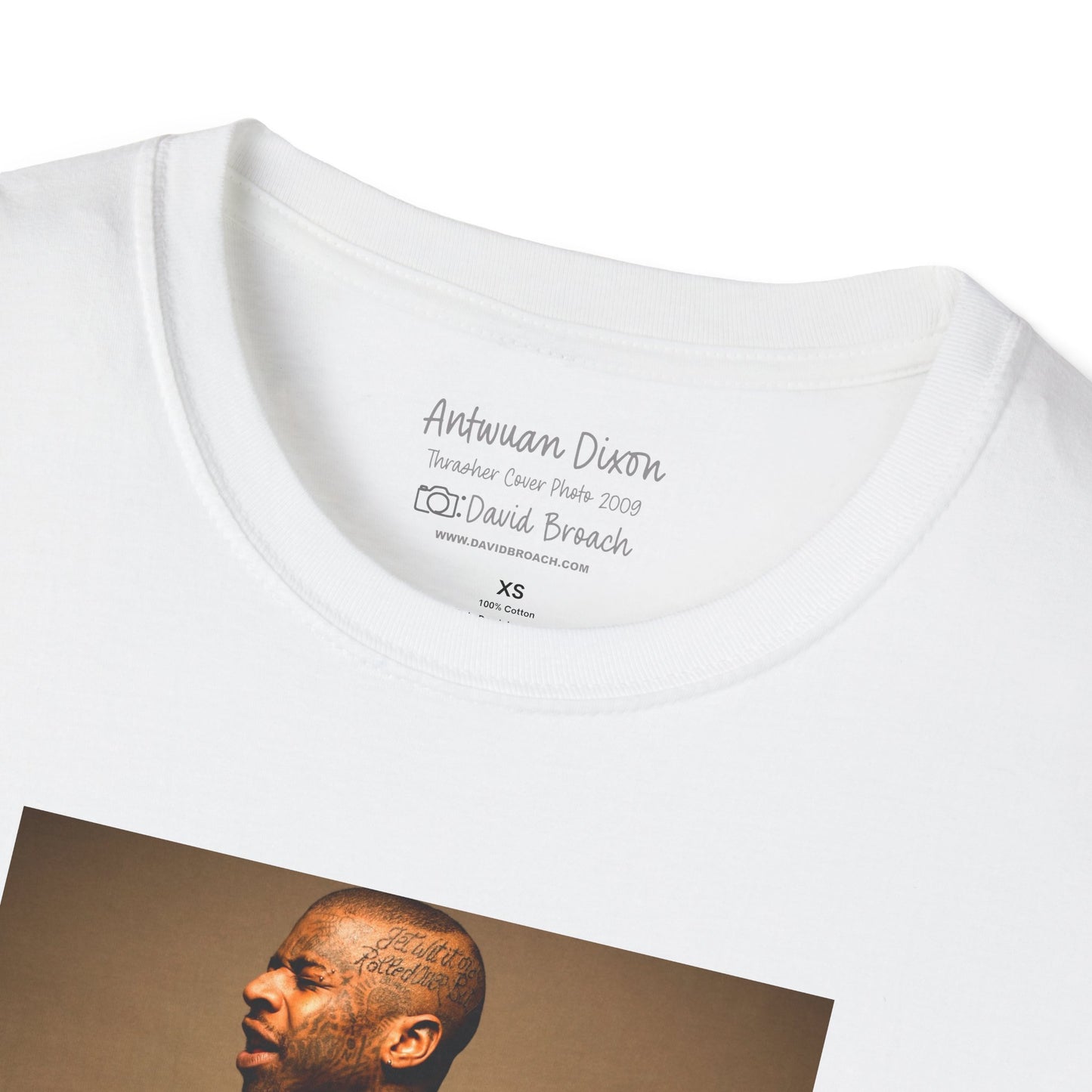 Close-up of a white crew neck collar short-sleeve T-shirt featuring 'Antwuan Dixon' and 'Photo by David Broach' printed on the inside. This subtle yet distinctive detail adds authenticity and exclusivity to the design, making it a must-have for skateboarding enthusiasts, streetwear collectors, and fans of iconic skate photography.
