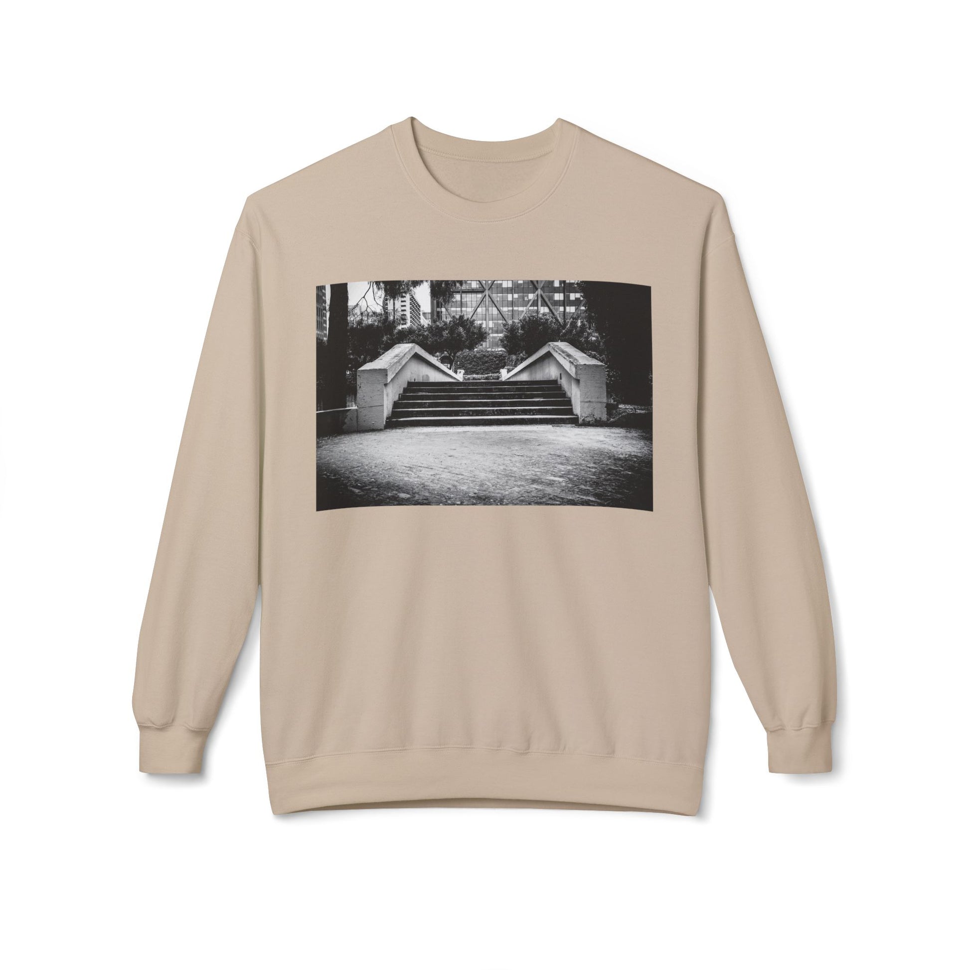 Front view of a cream long-sleeve sweatshirt.  The soft fabric drapes naturally, showcasing the relaxed fit. Ideal for layering or wearing solo, this piece adds a pop of color with a skate-inspired edge."