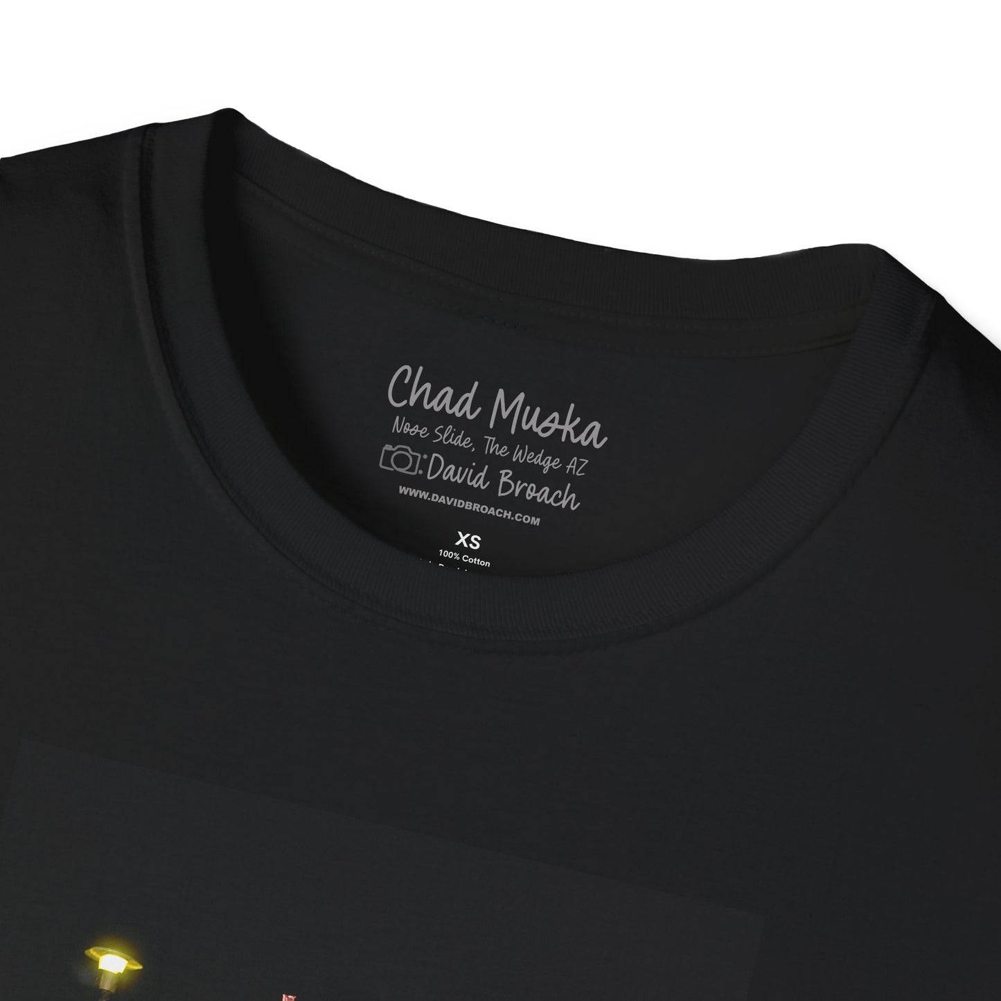 Close-up of the crew neck collar of a  black short-sleeve T-shirt featuring 'Chad Muska' and 'Photo by David Broach' printed on the inside. A subtle yet distinctive detail that adds authenticity to the design, making it a must-have for skateboarding enthusiasts and collectors.