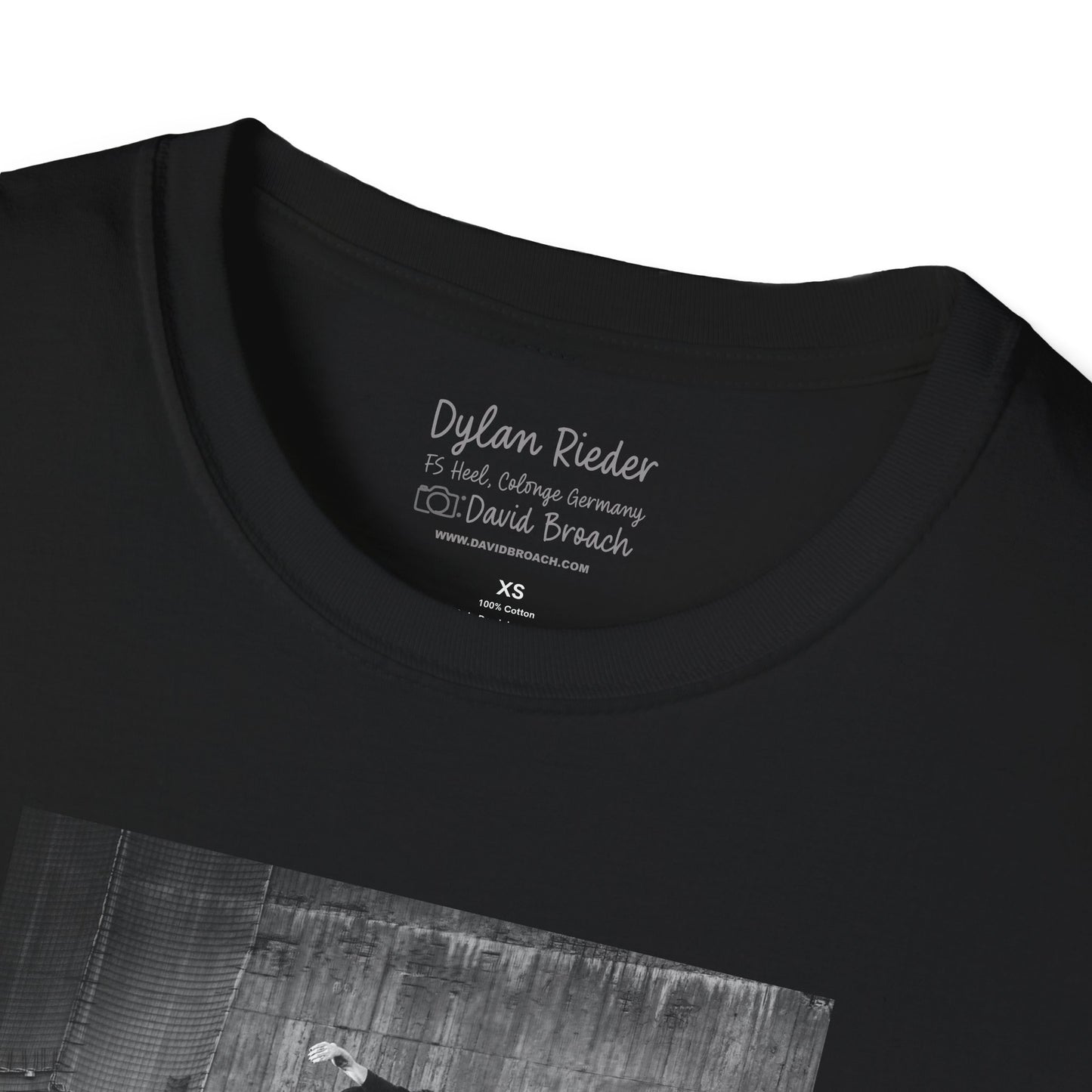 Close-up of a black crew neck collar of a short-sleeve T-shirt featuring 'Dylan Rieder' and 'Photo by David Broach' printed on the inside. A subtle yet distinctive detail that adds authenticity to the design, making it a must-have for skateboarding enthusiasts and collectors.
