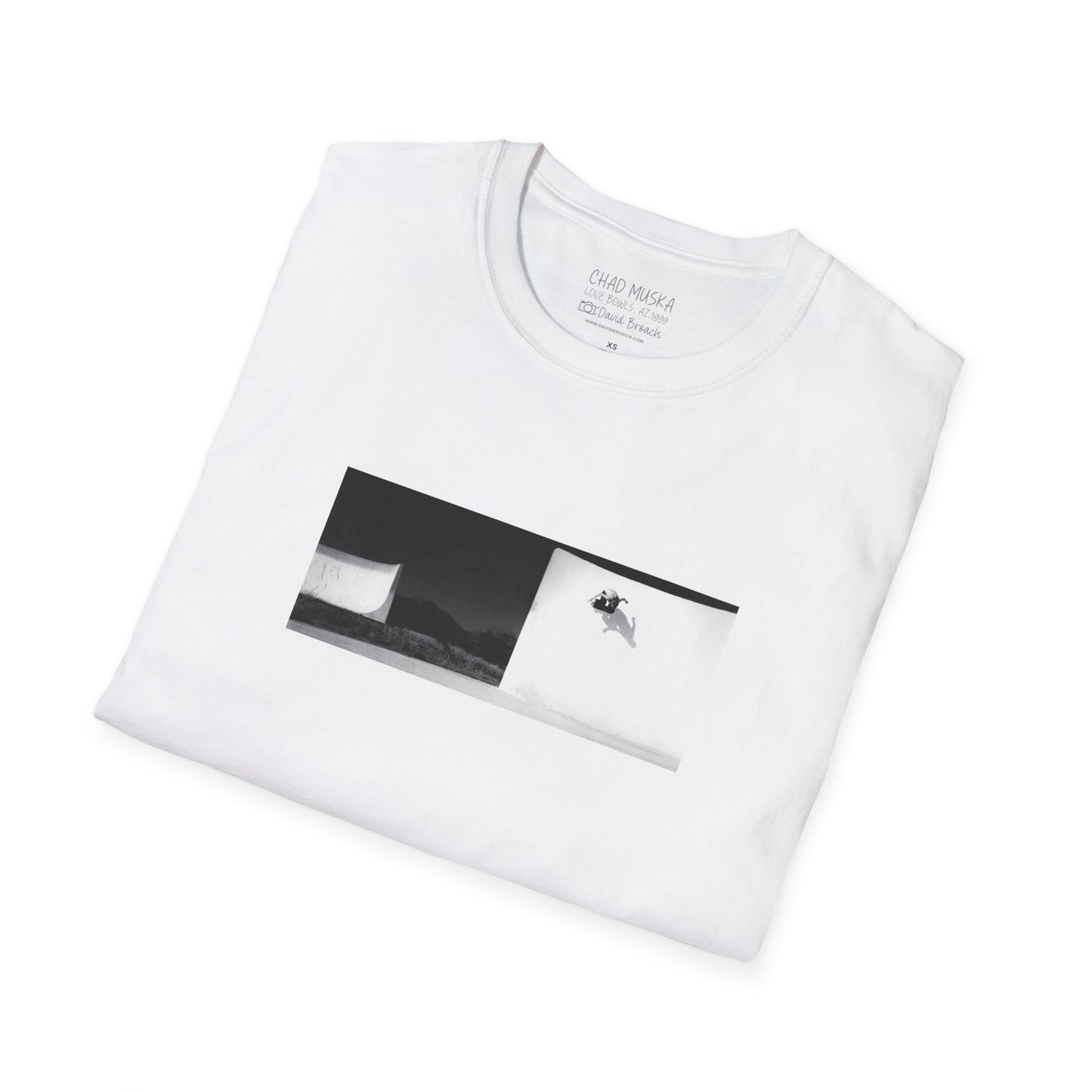 A neatly folded white crew neck short-sleeve T-shirt featuring a printed photo of Chad Muska doing a massive wallride at the Love Bowls in Phoenix, Arizona, circa 2000. Captured by photographer David Broach, the design highlights Muska’s raw power and effortless style, making it a must-have for skateboarding enthusiasts and streetwear fans.
