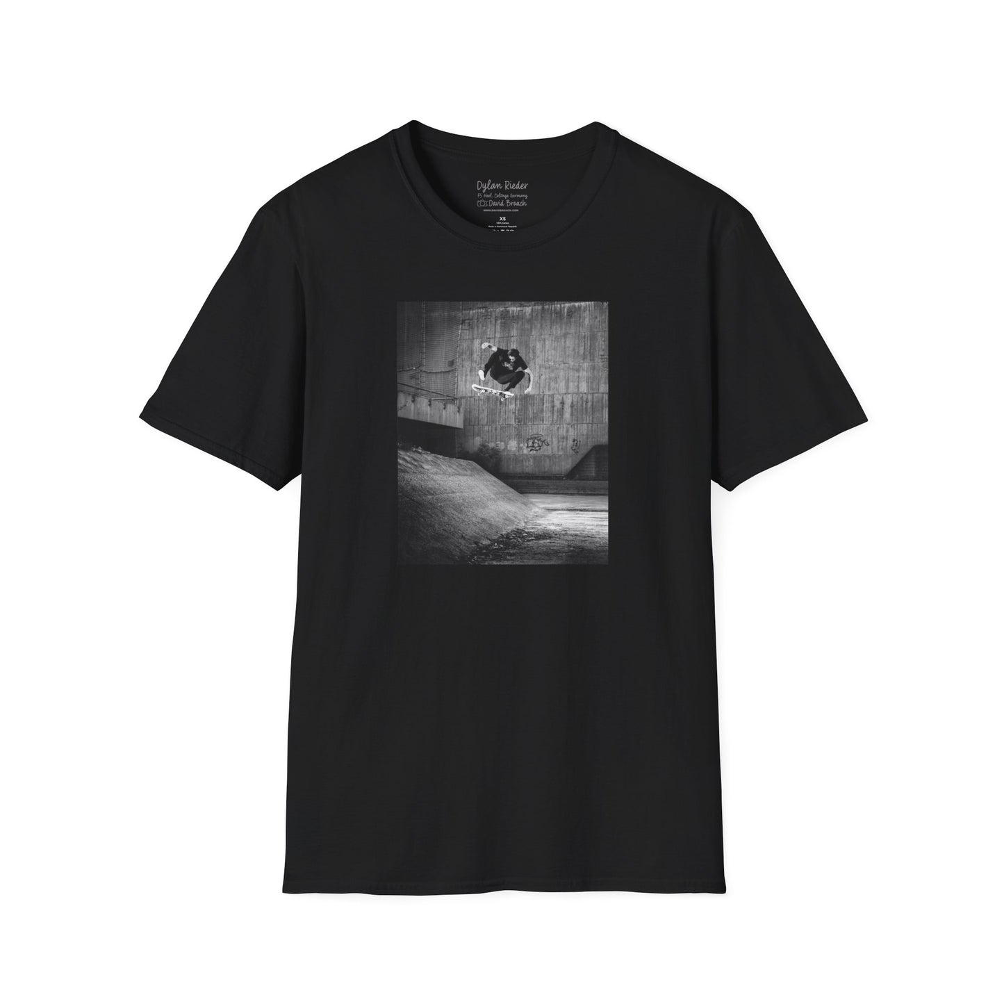 Black Short-sleeve crew neck T-shirt featuring a printed photo of Dylan Rieder executing a flawless frontside heelflip off a bump in Germany. Captured by photographer David Broach and featured on the Thrasher tribute cover, this design honors Dylan’s timeless style and effortless power, making it a must-have for skateboarding enthusiasts and collectors.