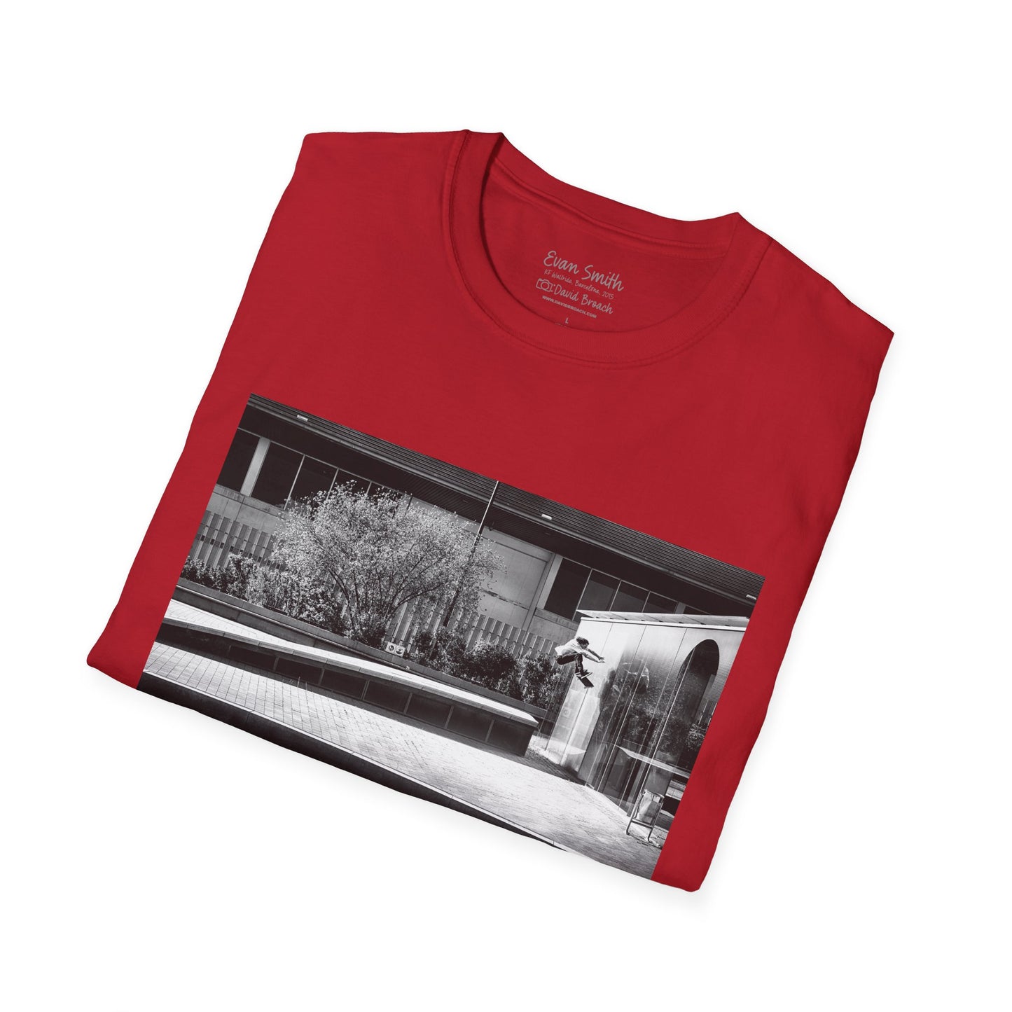 Red Shirt folded with print of Black and white photo of Evan Smith doing a kick flip wallride in Barcelona Spain. Off bump onto wall.