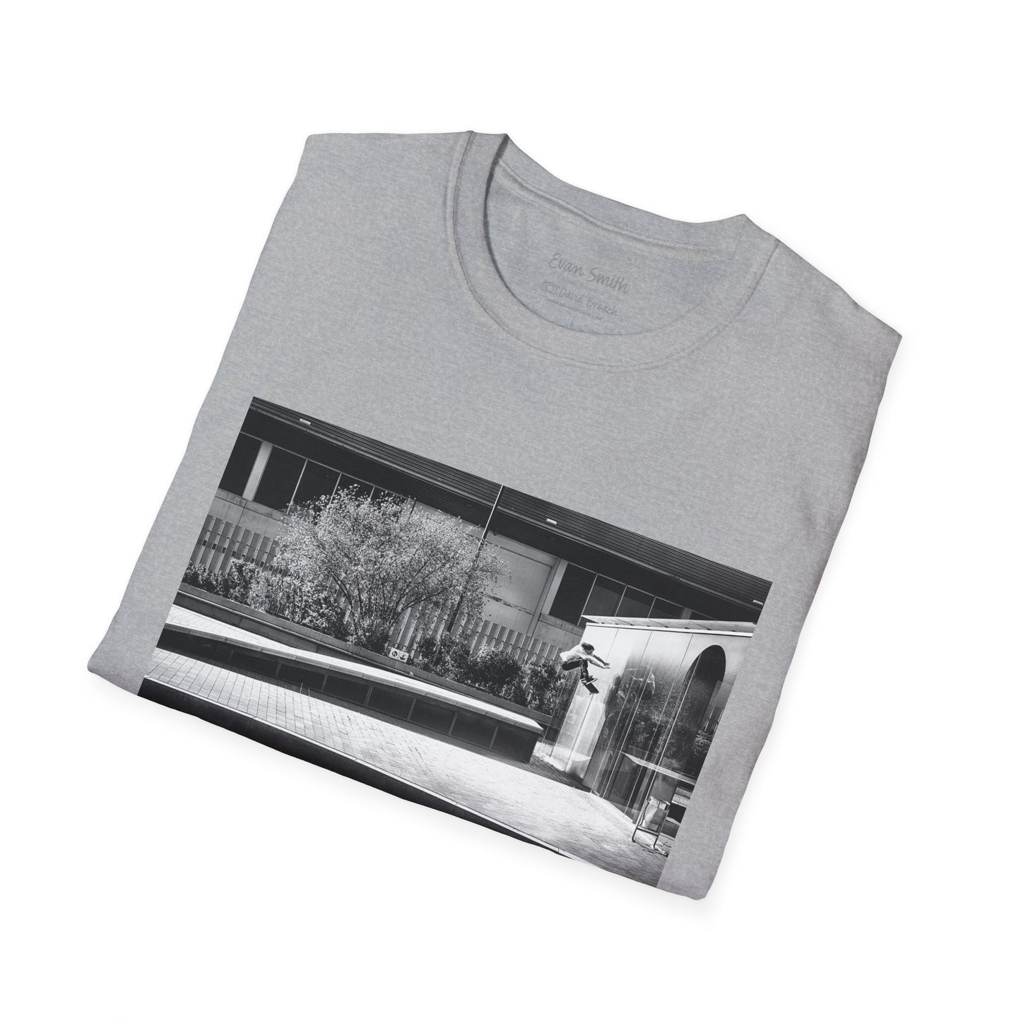 Neatly folded grey Shirt folded with print of Black and white photo of Evan Smith doing a kick flip wallride in Barcelona Spain. Off bump onto wall.