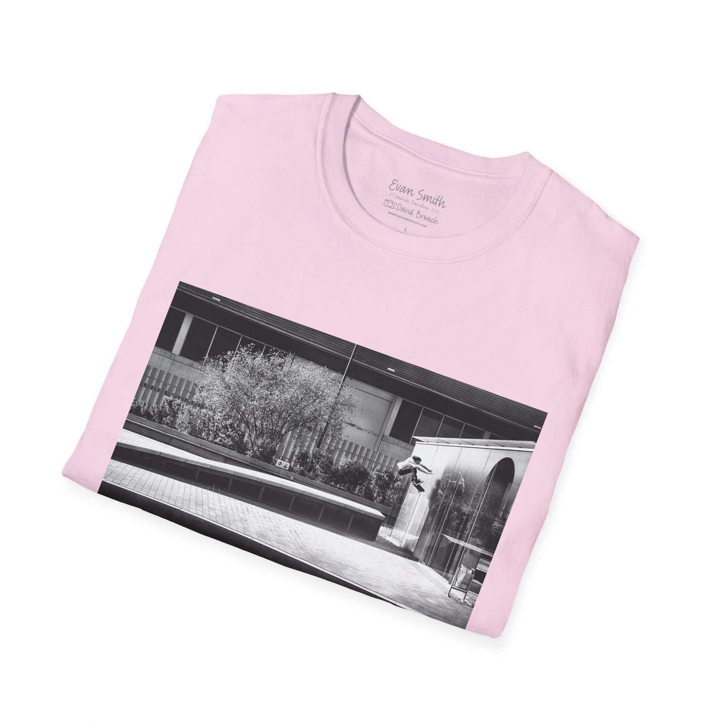 Pink Shirt folded with print of Black and white photo of Evan Smith doing a kick flip wallride in Barcelona Spain. Off bump onto wall.