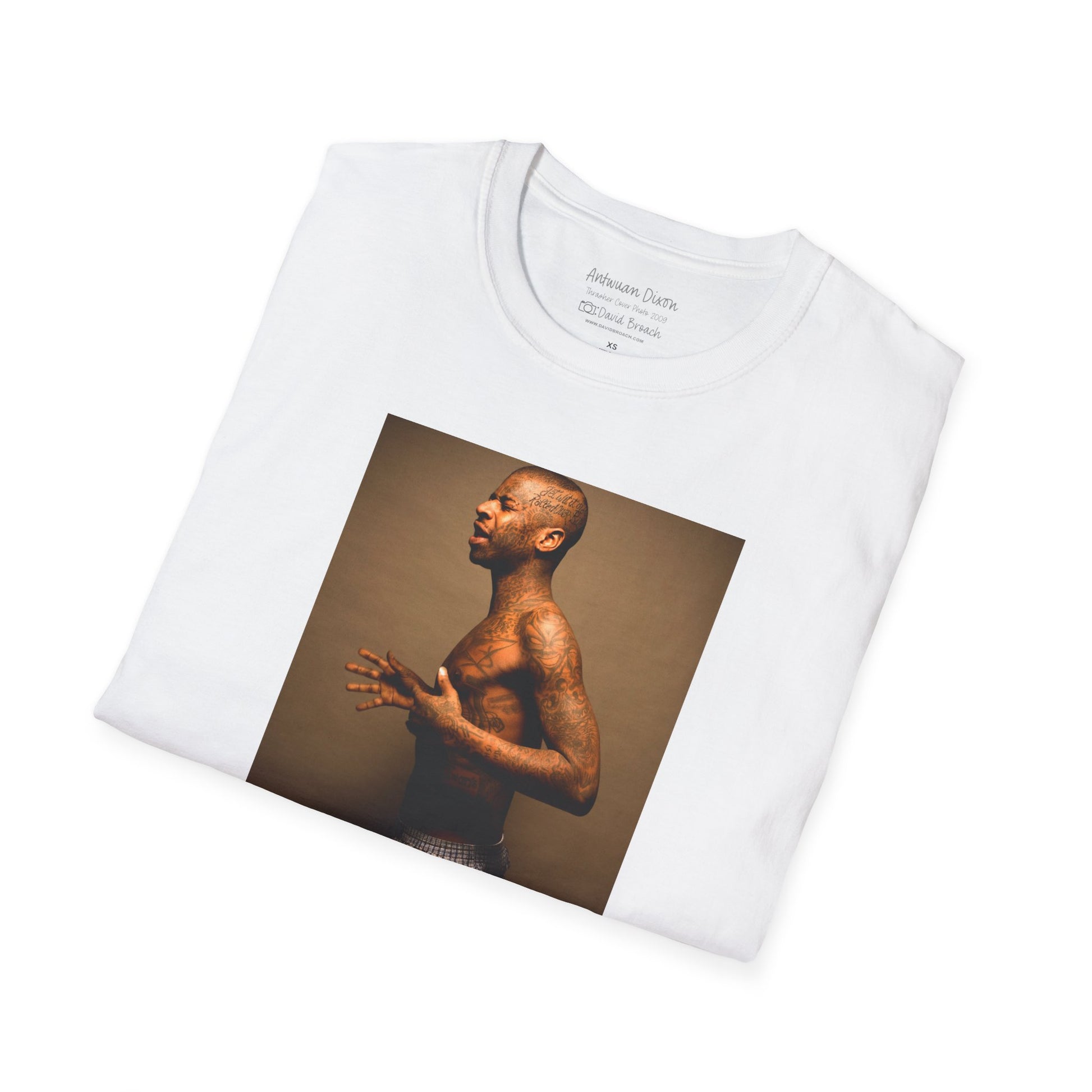 A neatly folded white crew neck short-sleeve T-shirt featuring a high-quality printed portrait of pro skater Antwuan Dixon, as seen on the cover of Thrasher Magazine. Captured by renowned skate photographer David Broach, this iconic design showcases Dixon’s unmistakable style and presence. Perfect for skateboarding enthusiasts, streetwear fans, and collectors looking for a statement piece.