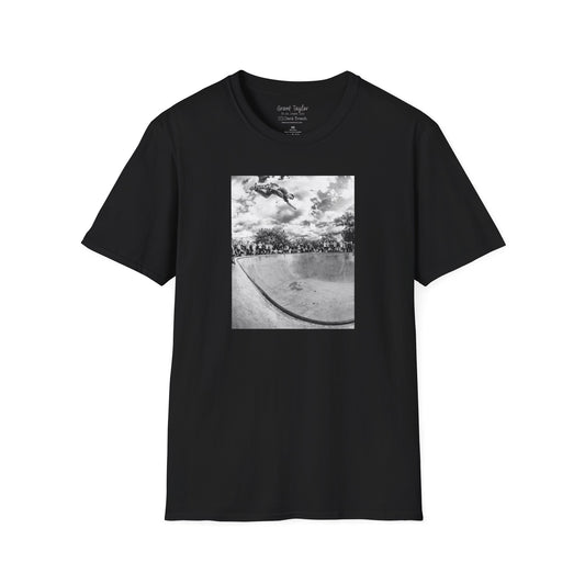 Photo of a black Short-sleeve crew neck T-shirt featuring a high-quality black-and-white photo of Grant Taylor blasting a massive backside air out of the deep end of a pool in London, England. Captured by renowned skate photographer David Broach, this striking design showcases Grant’s raw power and effortless style. A must-have for skateboarding enthusiasts, streetwear fans, and collectors of iconic skate photography.