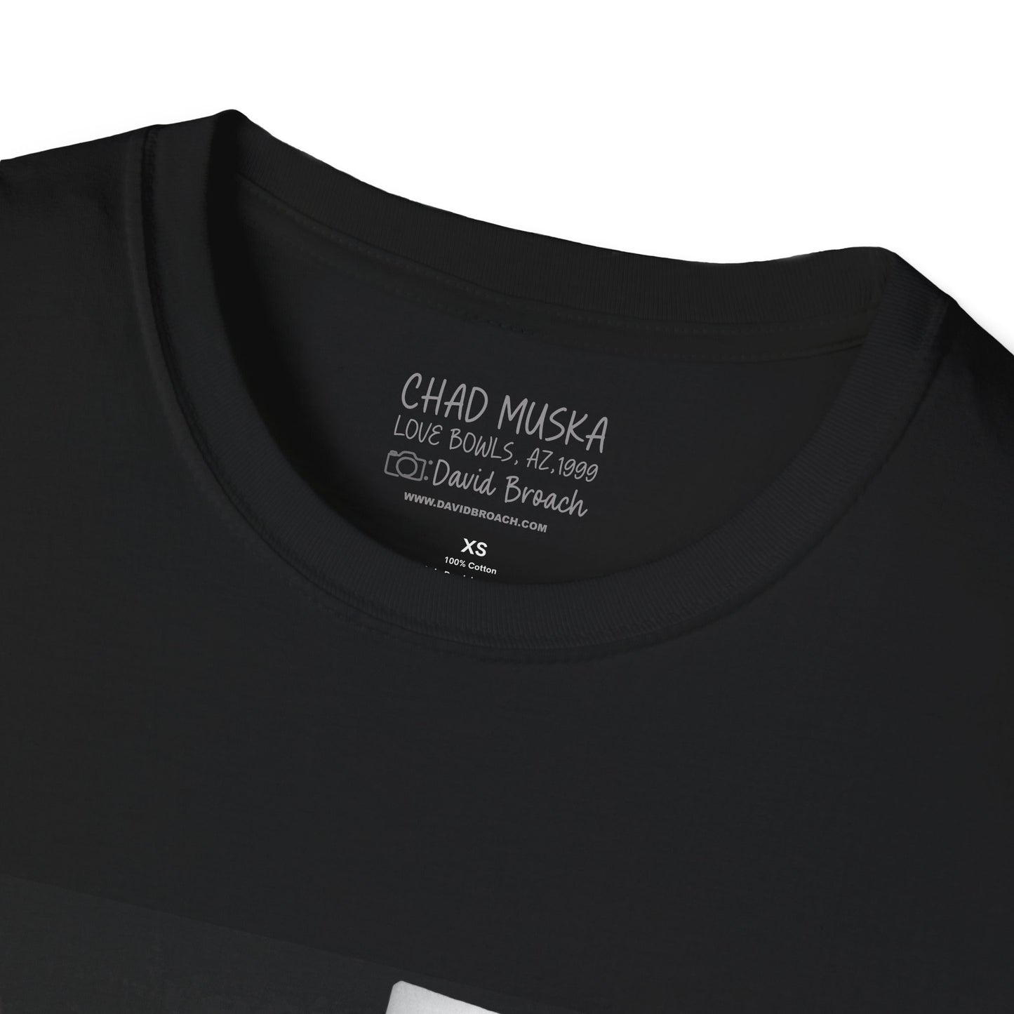 Close-up of the crew neck collar of a black short-sleeve T-shirt featuring 'Chad Muska' and 'Photo by David Broach' printed on the inside. A subtle yet distinctive detail that adds authenticity to the design, making it a must-have for skateboarding enthusiasts and collectors."