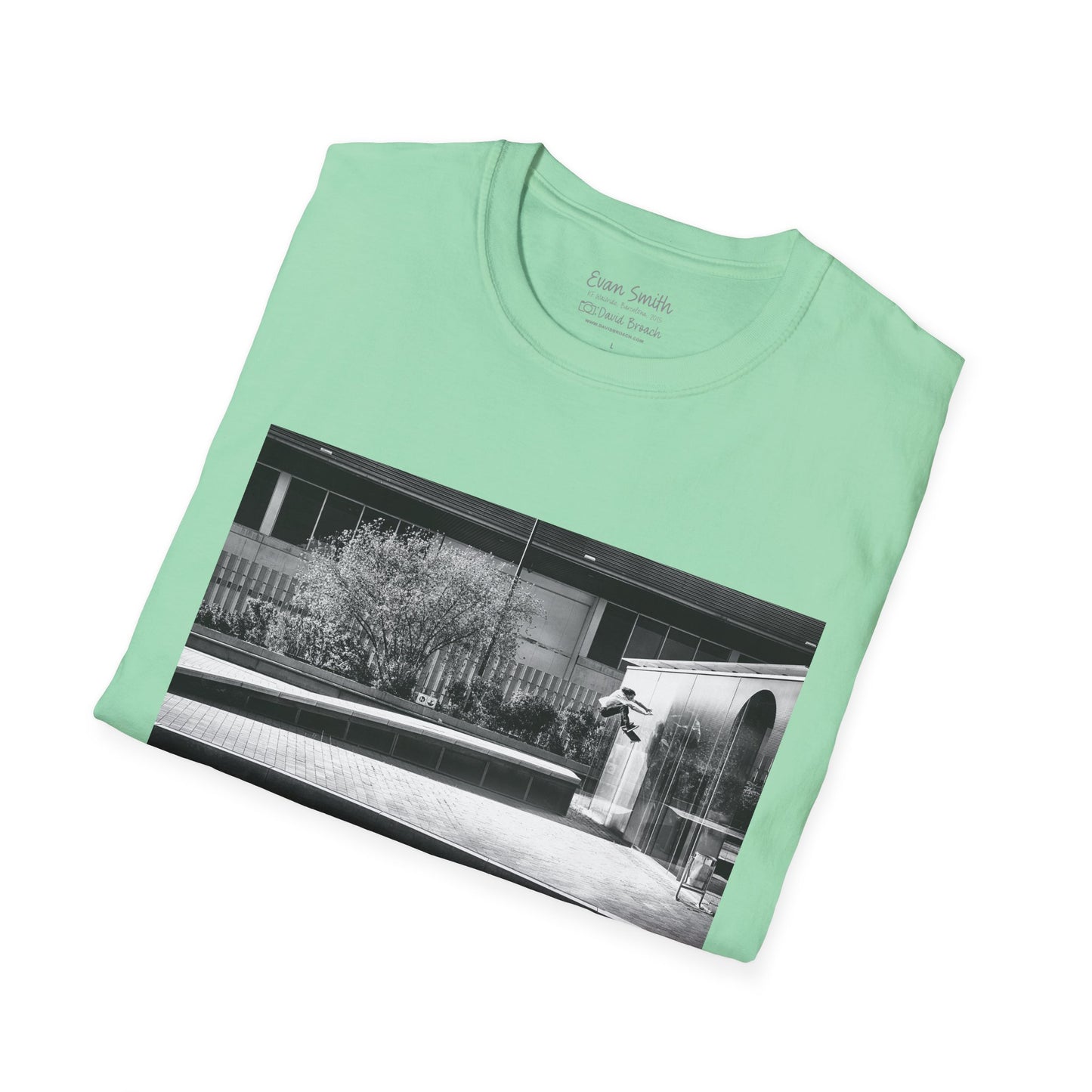 Mint Green Shirt folded with print of Black and white photo of Evan Smith doing a kick flip wallride in Barcelona Spain. Off bump onto wall.