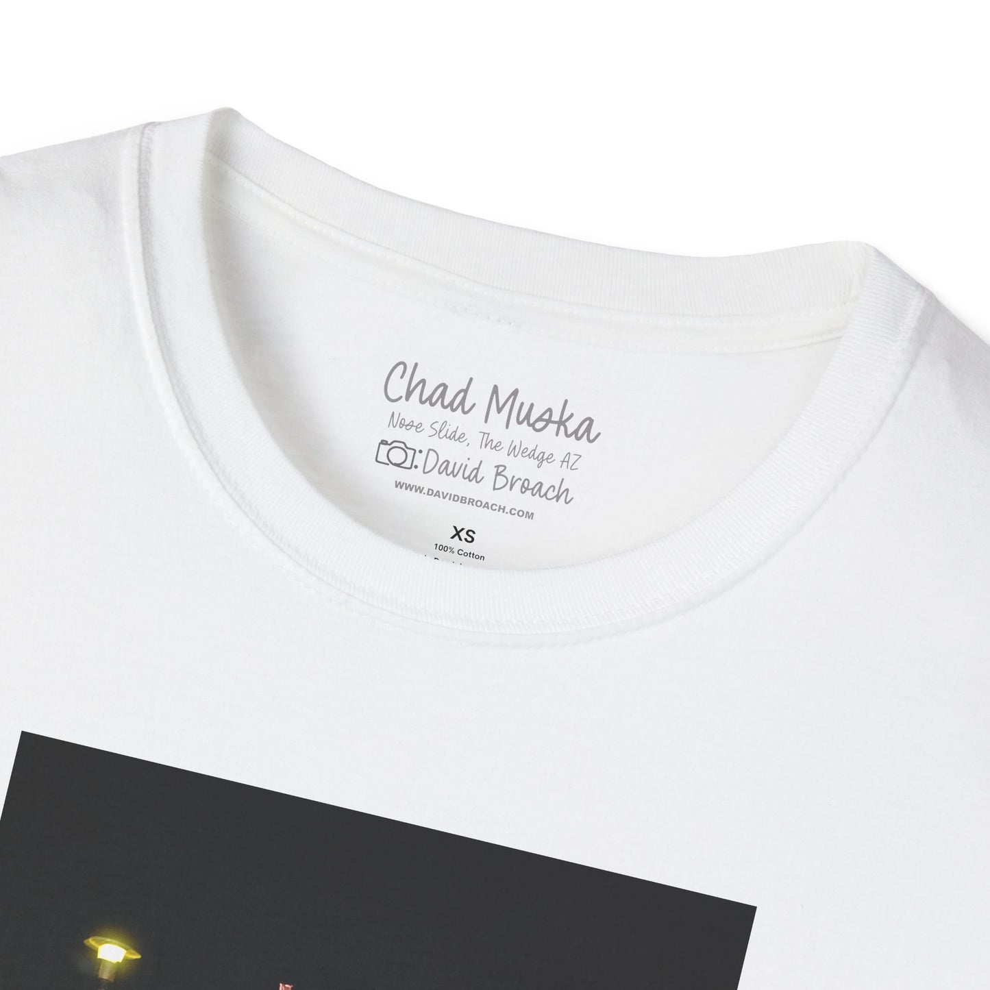 Close-up of the crew neck collar of a  white  short-sleeve T-shirt featuring 'Chad Muska' and 'Photo by David Broach' printed on the inside. A subtle yet distinctive detail that adds authenticity to the design, making it a must-have for skateboarding enthusiasts and collectors.