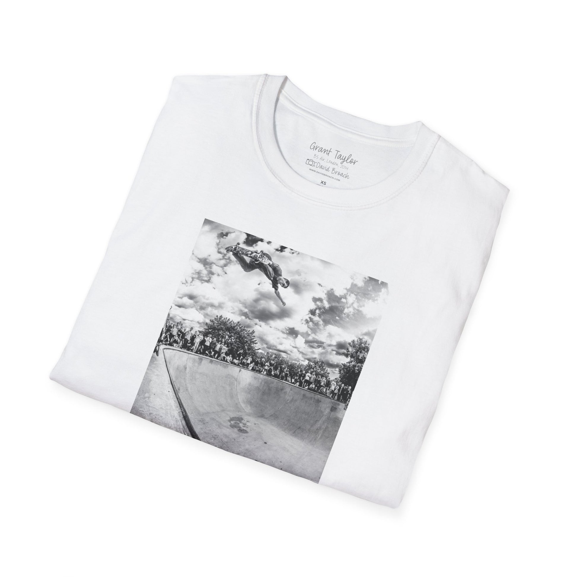 Photo of a neatly folded white Short-sleeve crew neck T-shirt featuring a high-quality black-and-white photo of Grant Taylor blasting a massive backside air out of the deep end of a pool in London, England. Captured by renowned skate photographer David Broach, this striking design showcases Grant’s raw power and effortless style. A must-have for skateboarding enthusiasts, streetwear fans, and collectors of iconic skate photography.