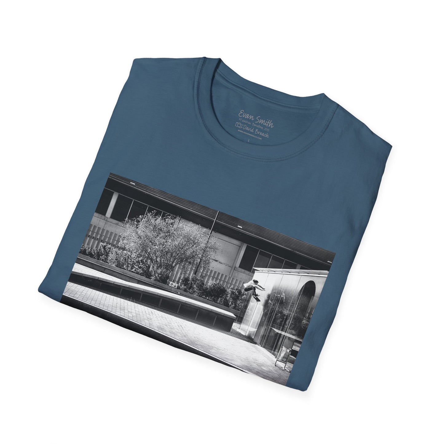 blue Shirt folded with print of Black and white photo of Evan Smith doing a kick flip wallride in Barcelona Spain. Off bump onto wall.