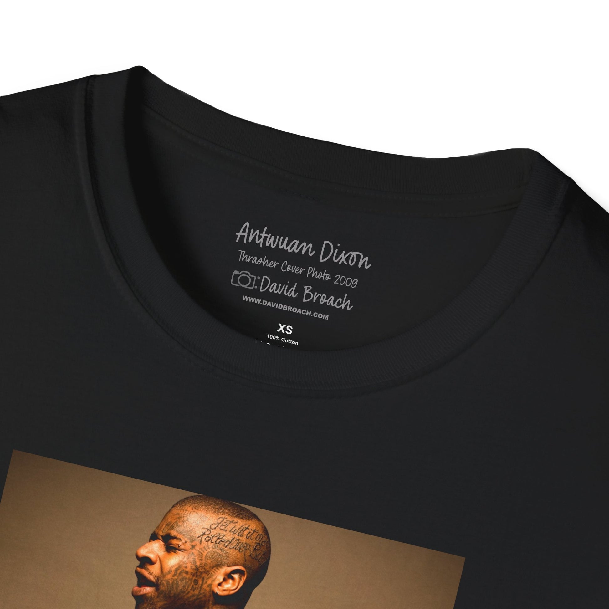 Close-up of a black crew neck collar short-sleeve T-shirt featuring 'Antwuan Dixon' and 'Photo by David Broach' printed on the inside. This subtle yet distinctive detail adds authenticity and exclusivity to the design, making it a must-have for skateboarding enthusiasts, streetwear collectors, and fans of iconic skate photography.