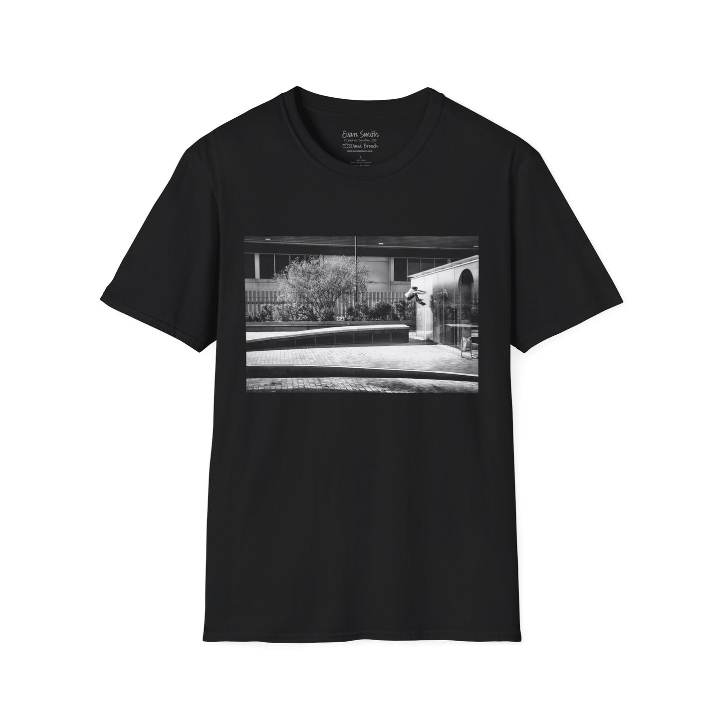 Black Shirt with print of Black and white photo of Evan Smith doing a kick flip wallride in Barcelona Spain. Off bump onto wall.