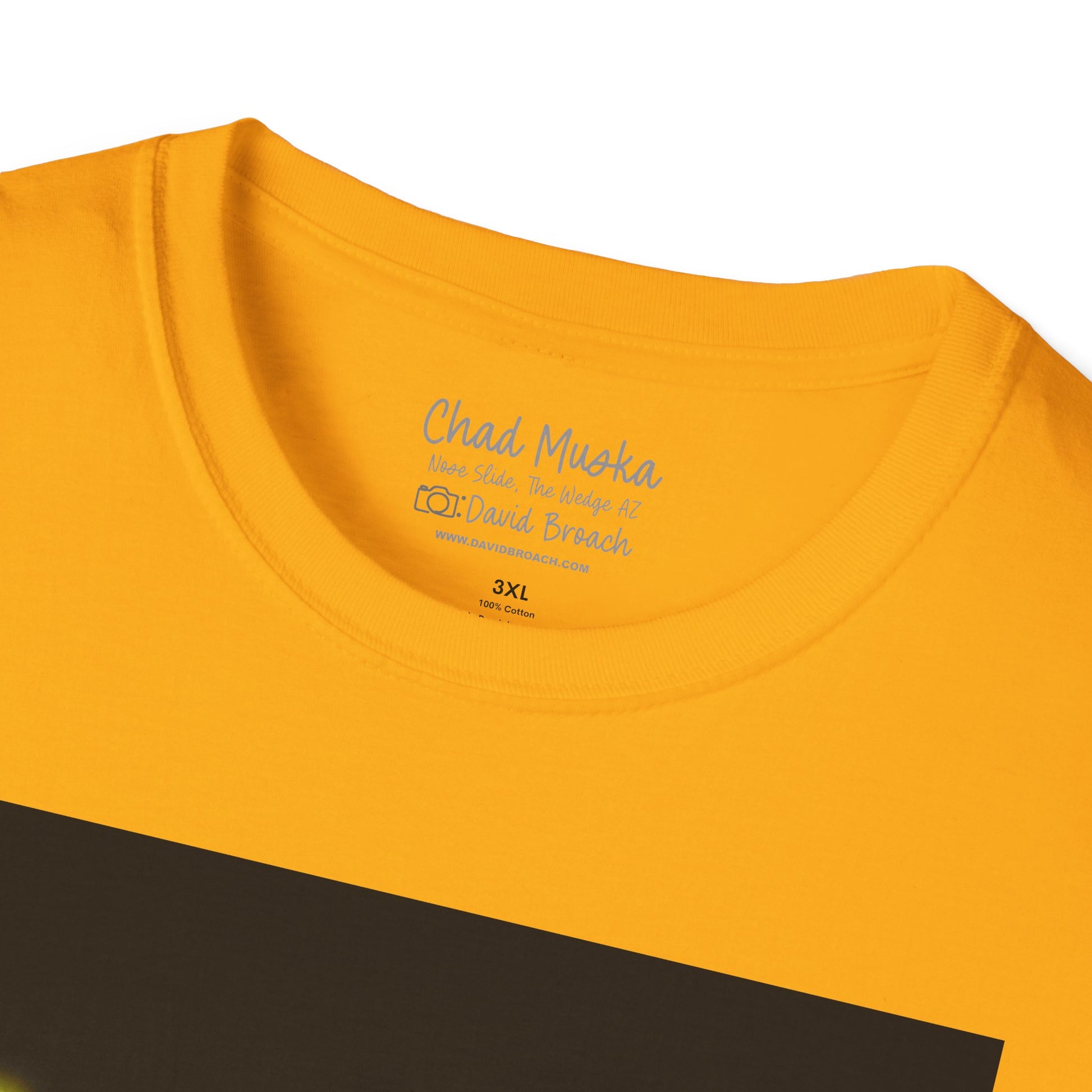 Close-up of the crew neck collar of a  yellow short-sleeve T-shirt featuring 'Chad Muska' and 'Photo by David Broach' printed on the inside. A subtle yet distinctive detail that adds authenticity to the design, making it a must-have for skateboarding enthusiasts and collectors.
