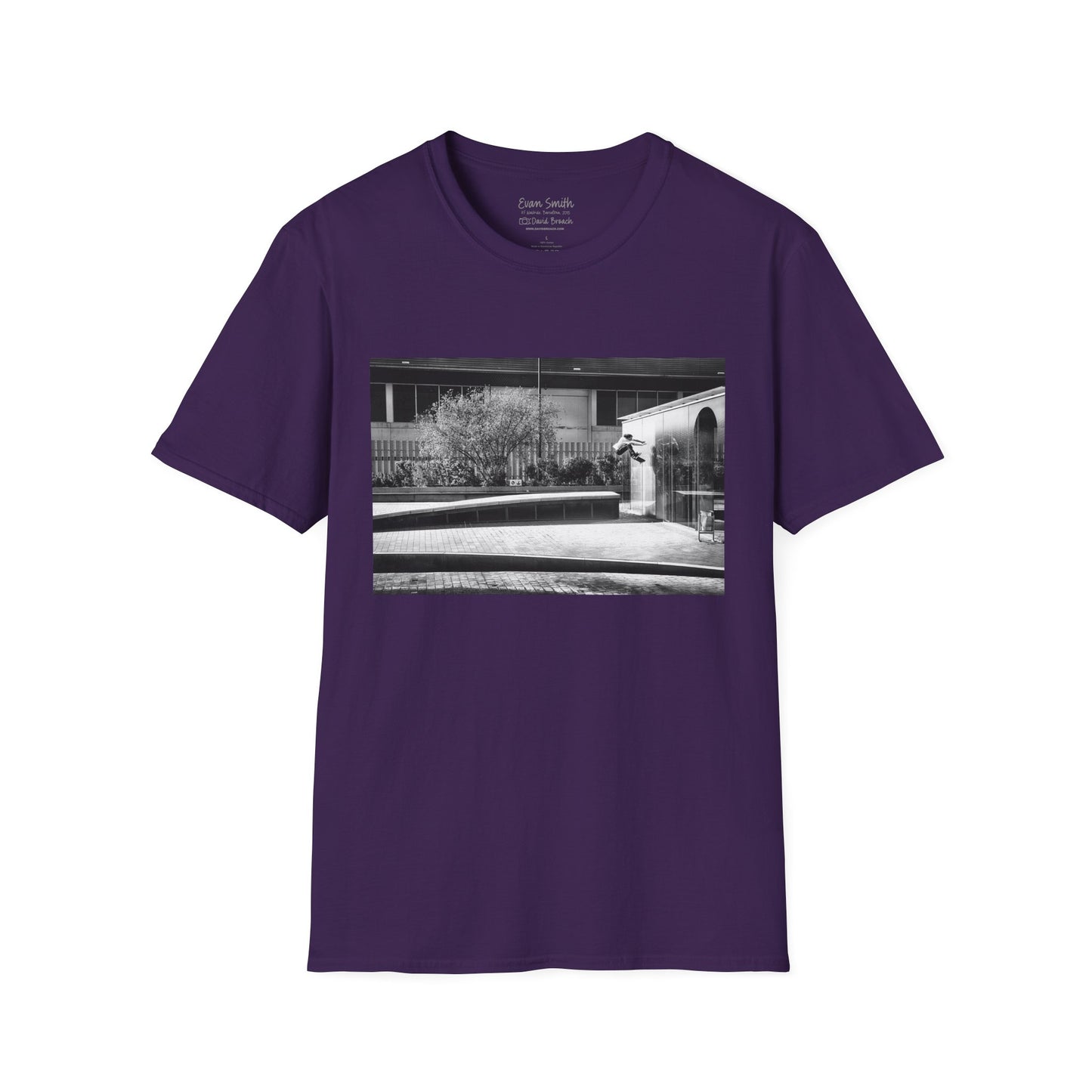 Purple Shirt folded with print of Black and white photo of Evan Smith doing a kick flip wallride in Barcelona Spain. Off bump onto wall.