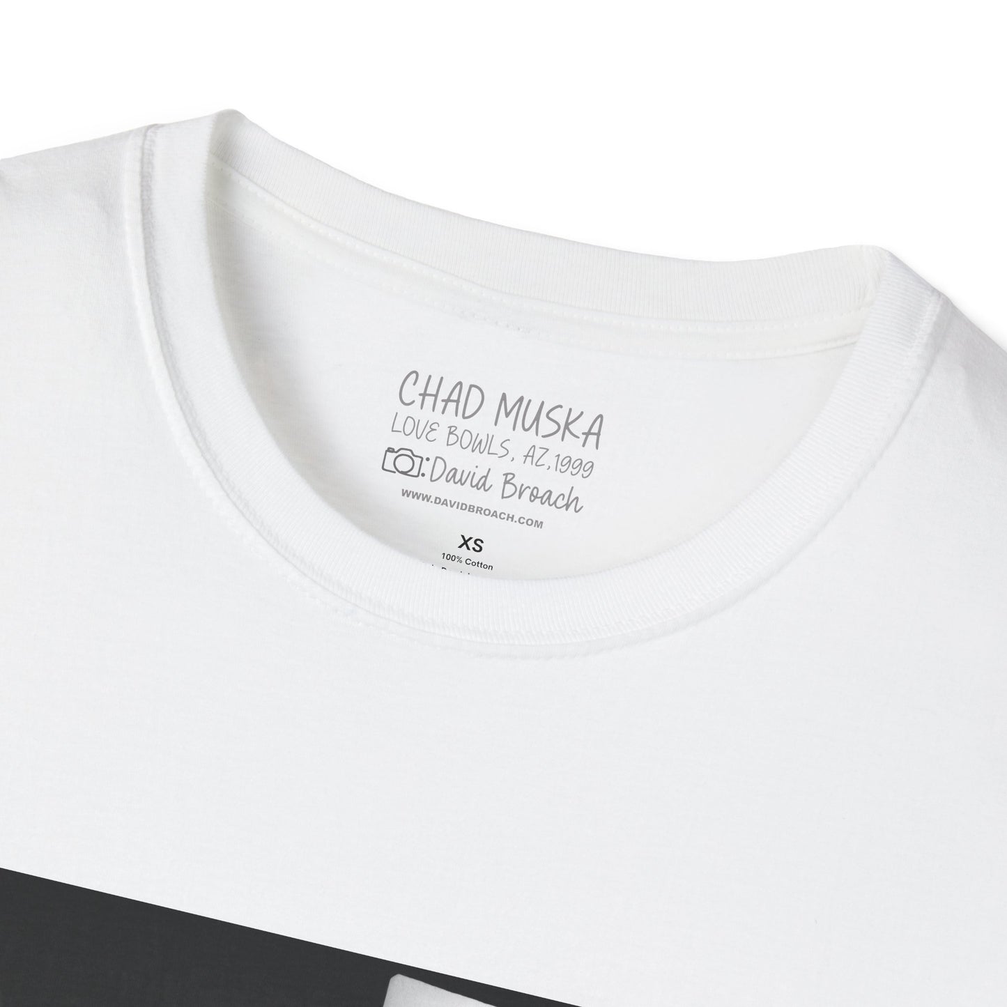 Close-up of the crew neck collar of a white short-sleeve T-shirt featuring 'Chad Muska' and 'Photo by David Broach' printed on the inside. A subtle yet distinctive detail that adds authenticity to the design, making it a must-have for skateboarding enthusiasts and collectors."