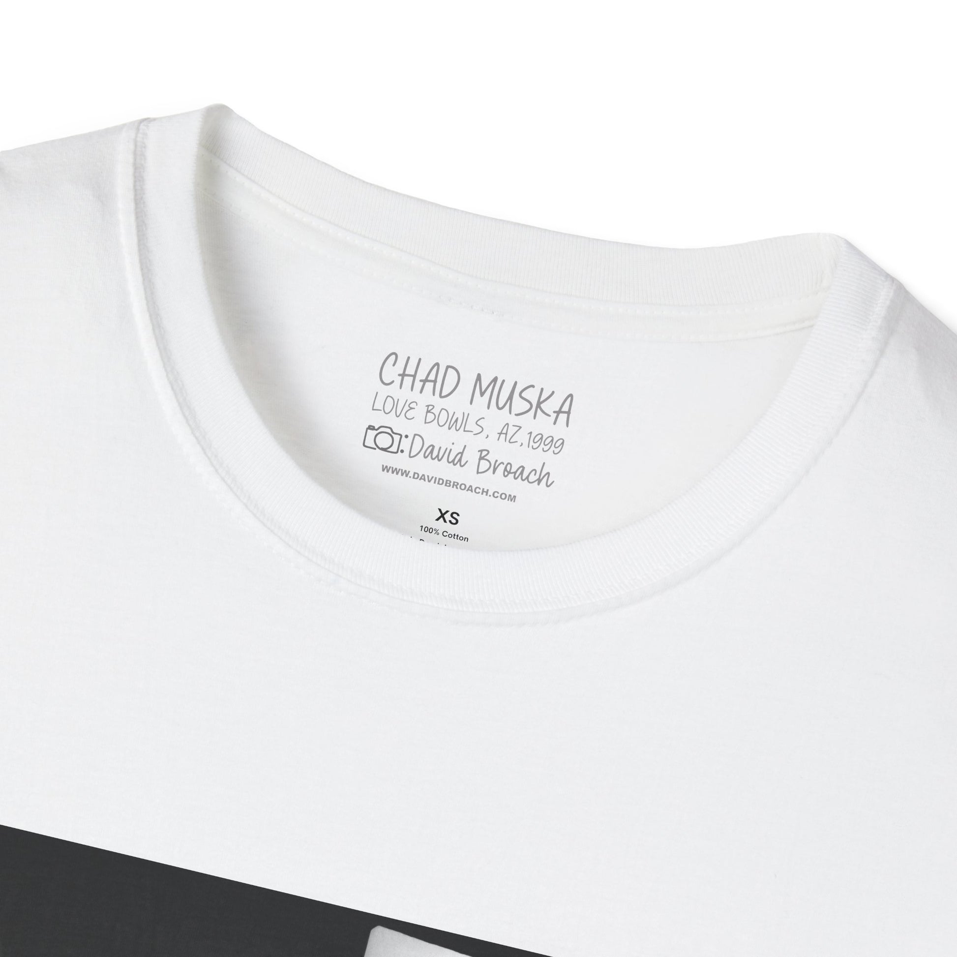 Close-up of the crew neck collar of a white short-sleeve T-shirt featuring 'Chad Muska' and 'Photo by David Broach' printed on the inside. A subtle yet distinctive detail that adds authenticity to the design, making it a must-have for skateboarding enthusiasts and collectors."