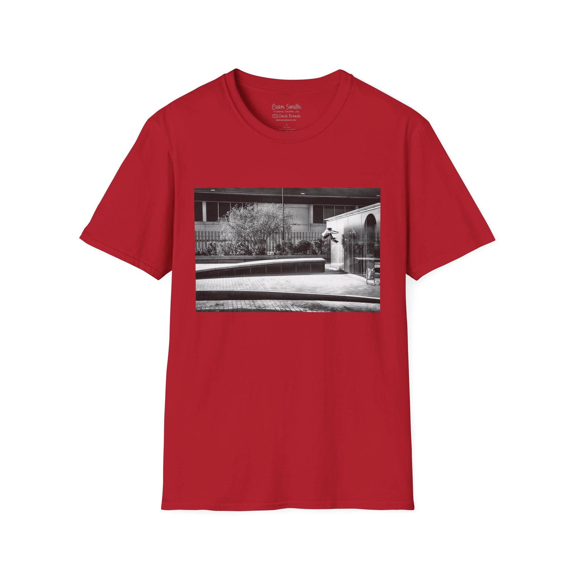 Red Shirt with print of Black and white photo of Evan Smith doing a kick flip wallride in Barcelona Spain. Off bump onto wall.