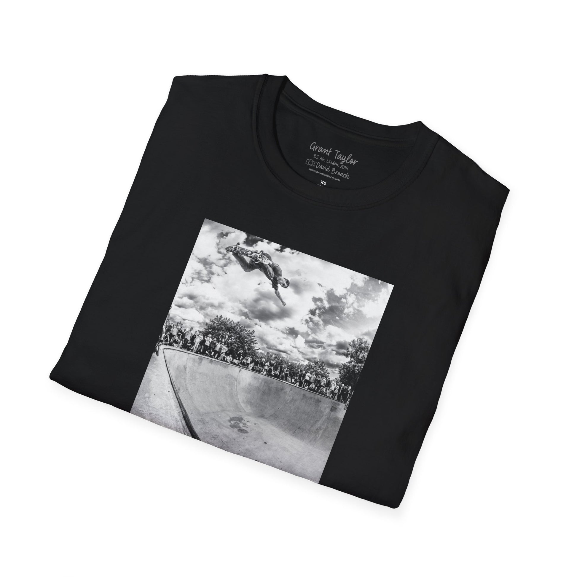 Photo of a neatly folded black Short-sleeve crew neck T-shirt featuring a high-quality black-and-white photo of Grant Taylor blasting a massive backside air out of the deep end of a pool in London, England. Captured by renowned skate photographer David Broach, this striking design showcases Grant’s raw power and effortless style. A must-have for skateboarding enthusiasts, streetwear fans, and collectors of iconic skate photography.