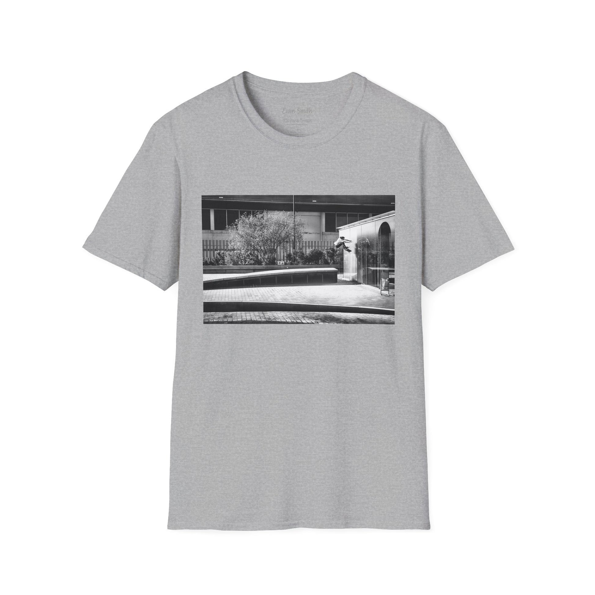 Grey Shirt with print of Black and white photo of Evan Smith doing a kick flip wallride in Barcelona Spain. Off bump onto wall.