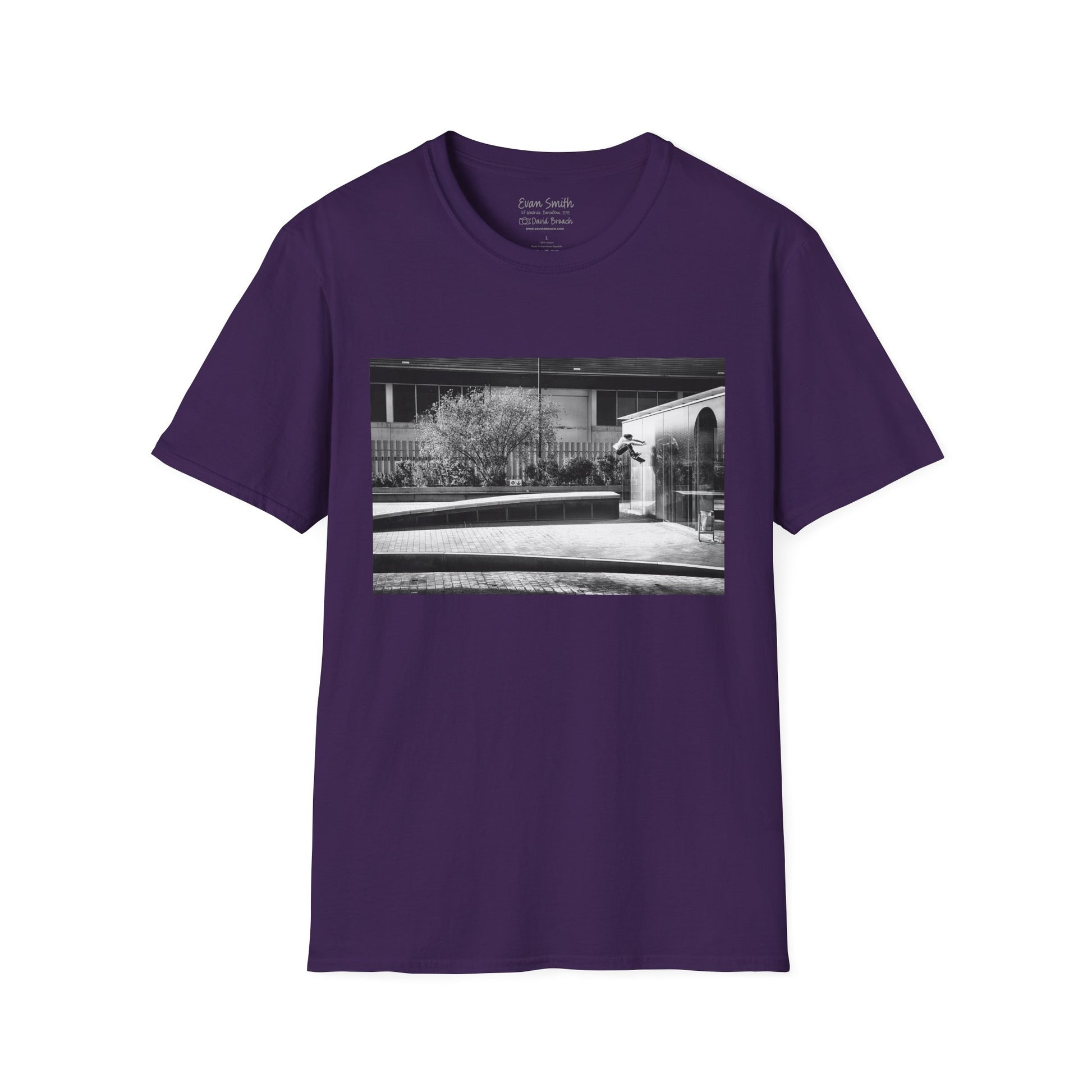 Purple Shirt folded with print of Black and white photo of Evan Smith doing a kick flip wallride in Barcelona Spain. Off bump onto wall.